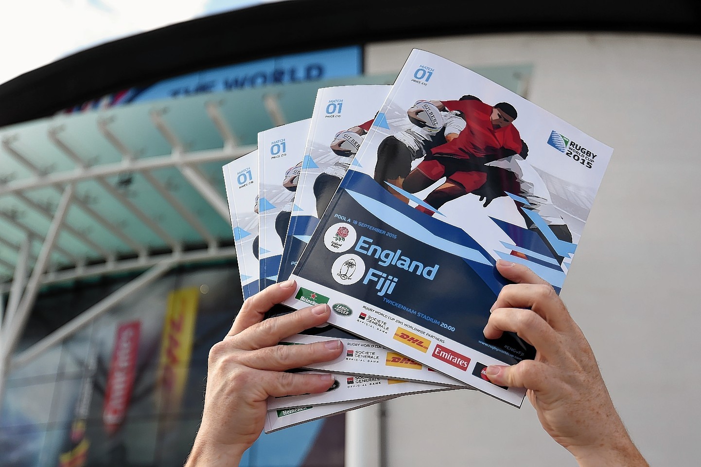 A programme seller holds up programmes ahead of tonight's opening match at Twickenham