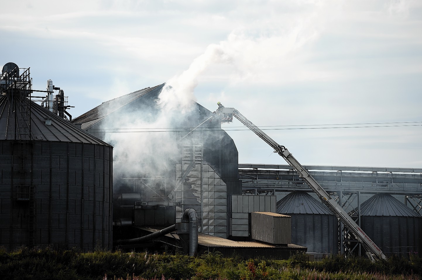 Firefighters hose down the fire in a grain drier at Tore, near Inverness. Picture by Gordon Lennox