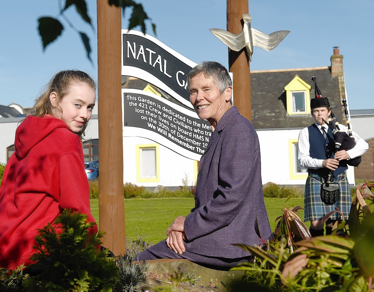 Granddaughter of Captain Back, Rosalind Cahill with Primary seven pupil of Cromarty Primary School, Mairi McNaught, with piper Kenan Widdows, 14, of Invergordon Academy