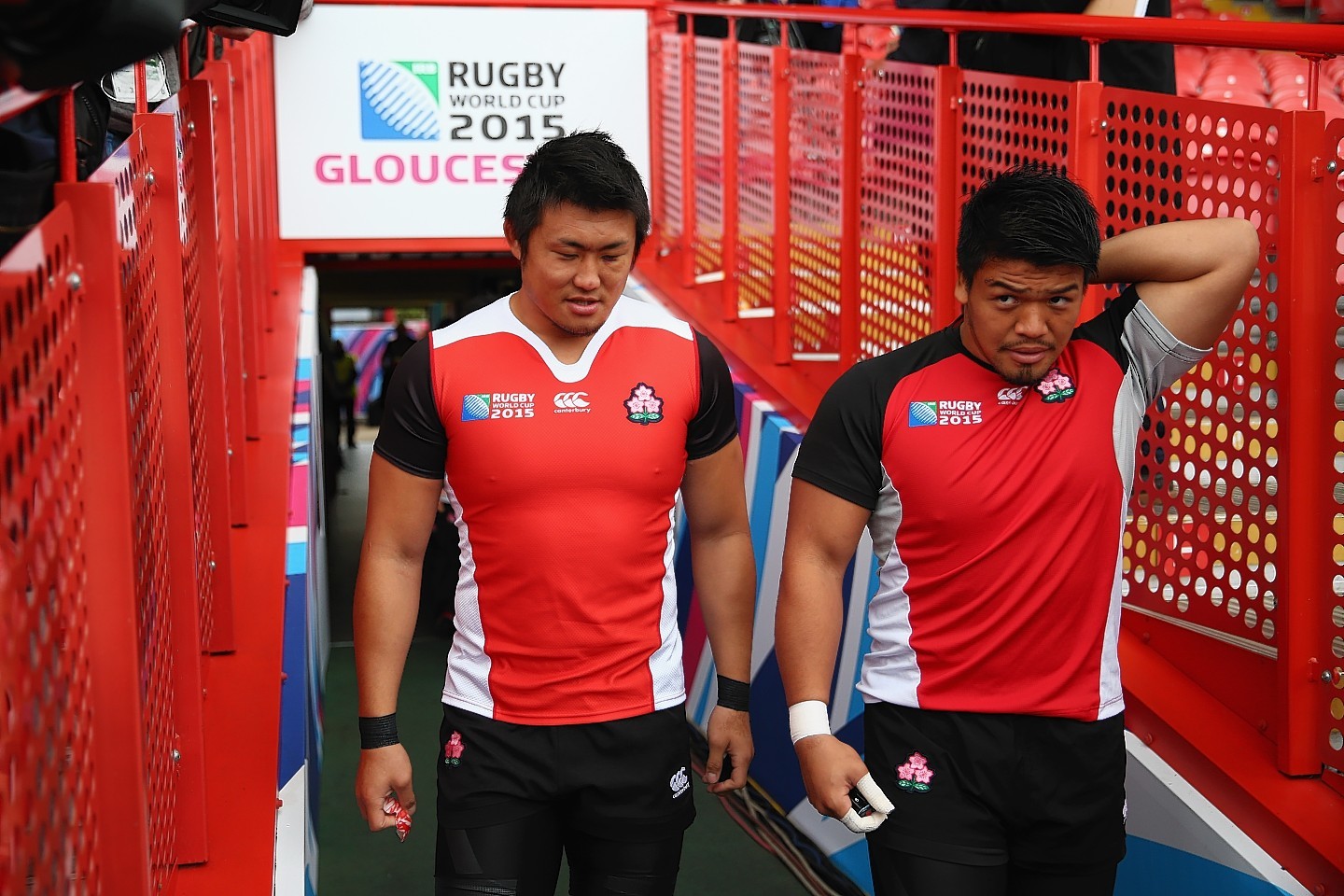 Shinya Makabe (L) and Takeshi Kizu (R) of Japan head towards the pitch from the dressing rooms during the Captain's Run ahead of the Japan versus Scotland Pool B match at Kingsholm Stadium