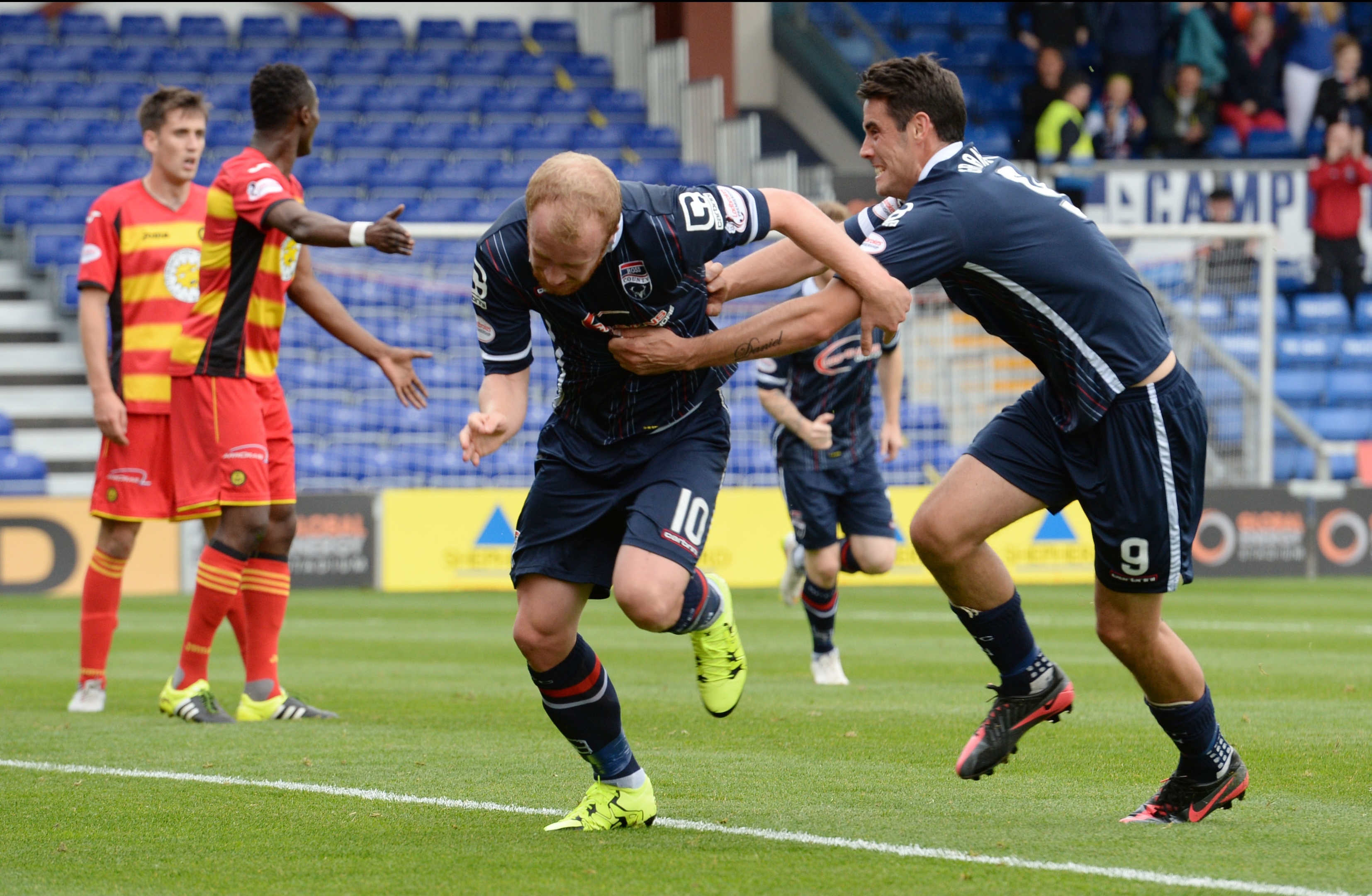 Liam Boyce (centre) races off to celebrate after scoring for Ross County