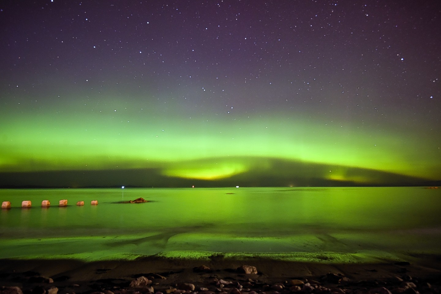 The Aurora Borealis, also known as the Northern Lights, are seen lighting up the sea by the West Beach in Lossiemouth, Moray 