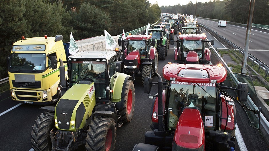 Farmers drive their tractors on a highway leading to Paris to join a protest over falling French food prices and high taxes. They are protesting increasingly slim margins they blame on cheap imports and high wage charges. (AP)