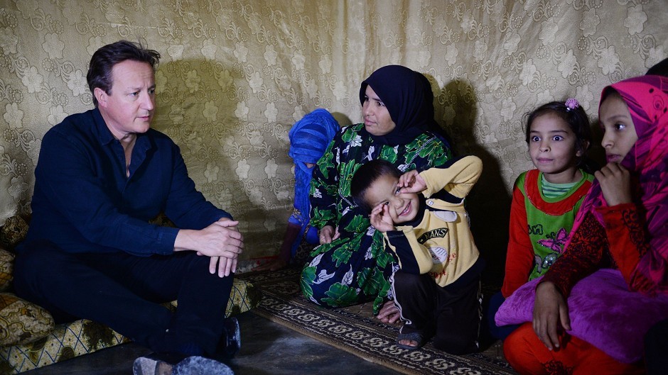 David Cameron meets Syrian refugee families at a tented settlement camp in the Bekaa Valley on the Syrian - Lebanese border.