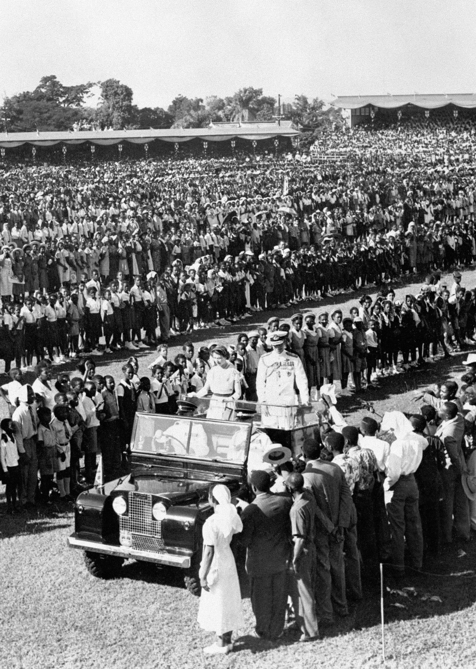 1953 Queen Elizabeth II and the Duke of Edinburgh pass through long lines of schoolchildren at a youth rally to greet the royal couple in Sabina Park, Kingston, Jamaica. Jamaica's new Prime Minister has vowed to abandon the Queen as head of state weeks after it was announced Prince Harry will make a Diamond Jubilee visit to the country. PRESS ASSOCIATION Photo. Issue date: Friday January 6, 2012. Portia Simpson Miller's pledge came as she took the oath of office and she said her administration would adopt a republican form of government. 