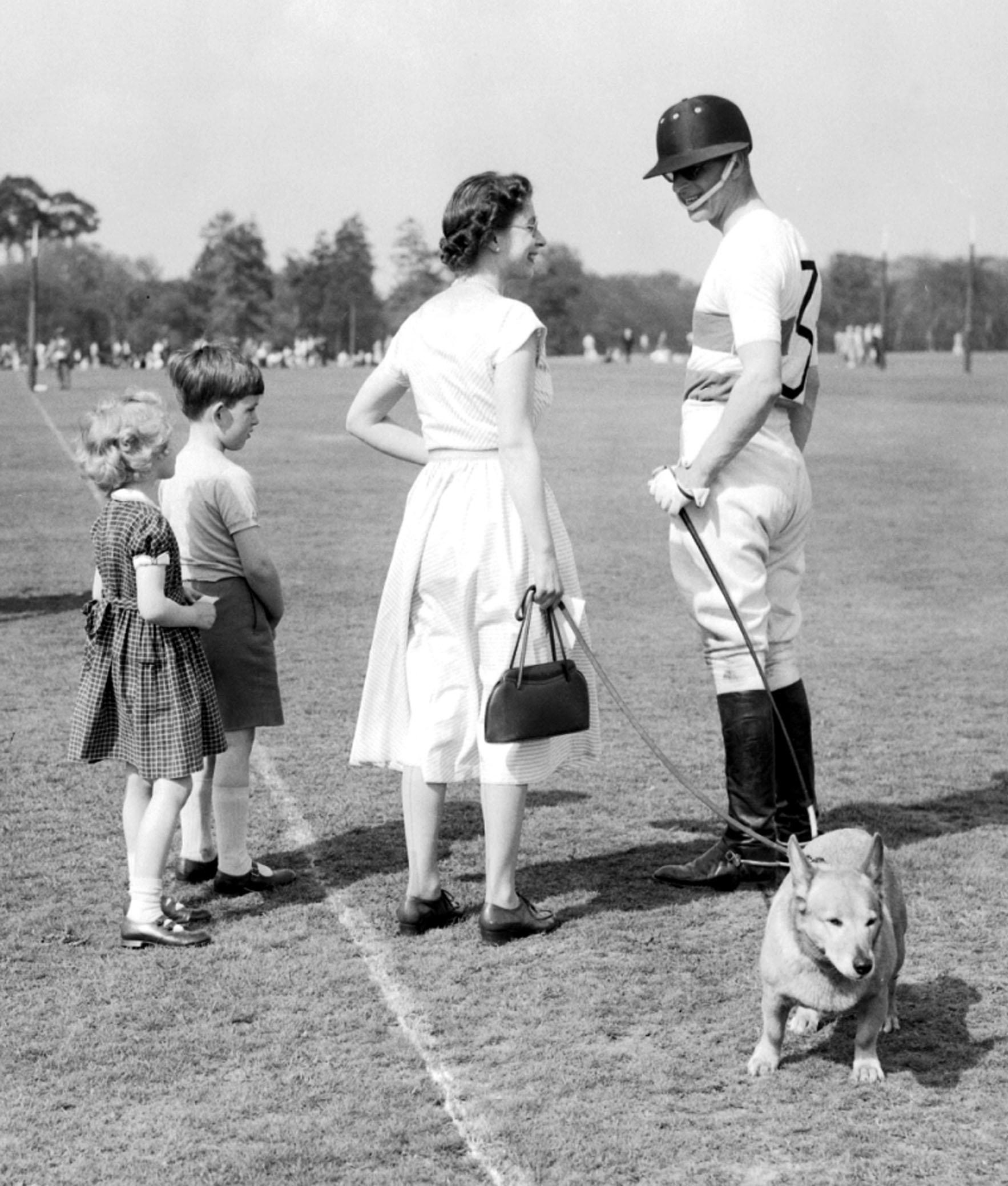 The Queen, with one of the Royal corgis, chats with polo-playing Prince Philip at Smith's Lawn, Windsor Great Park, on May 6 1956. ... The Queen chats with the Duke of Edinburgh ... 1976 