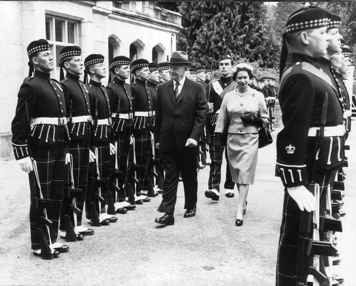 The Queen accompanies President Eisenhower on an inspection of the guard at the gates of Balmoral Castle, during the US president's visit in 1959. 