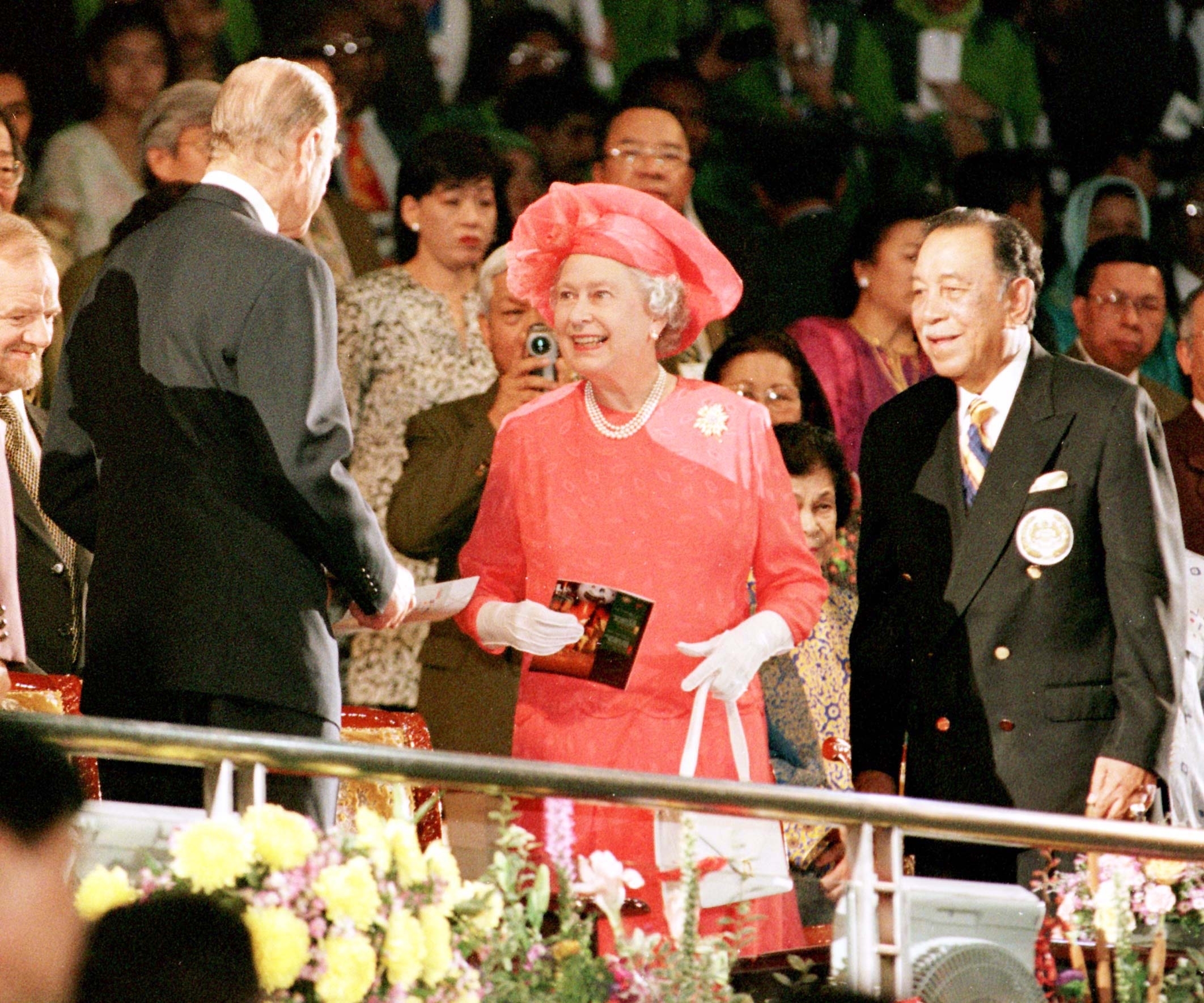 The Queen shares a smile with the Duke of Edinburgh in the Royal box during the closing ceremony of the Commonwealth Games tonight (Monday). The Agong (King) of Malaysia, Raja Permaisuri, is on the right and Foreign Secretary Robin Cook is far left. 