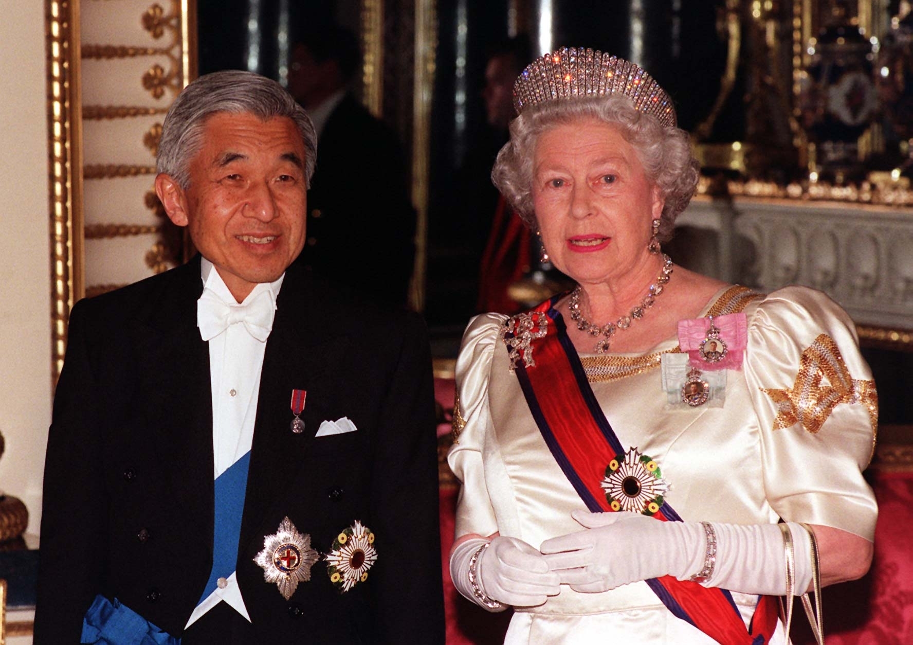 Britain's Queen Elizabeth II accompanies Japanese Emperor Akihito to the State Banquet Hall at Buckingham Palace