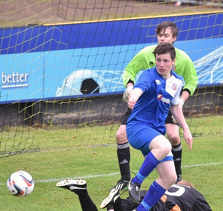 Rothes goalmouth scramble as Rothes' Nathan Smith stands on the leg of Huntly's David Booth.