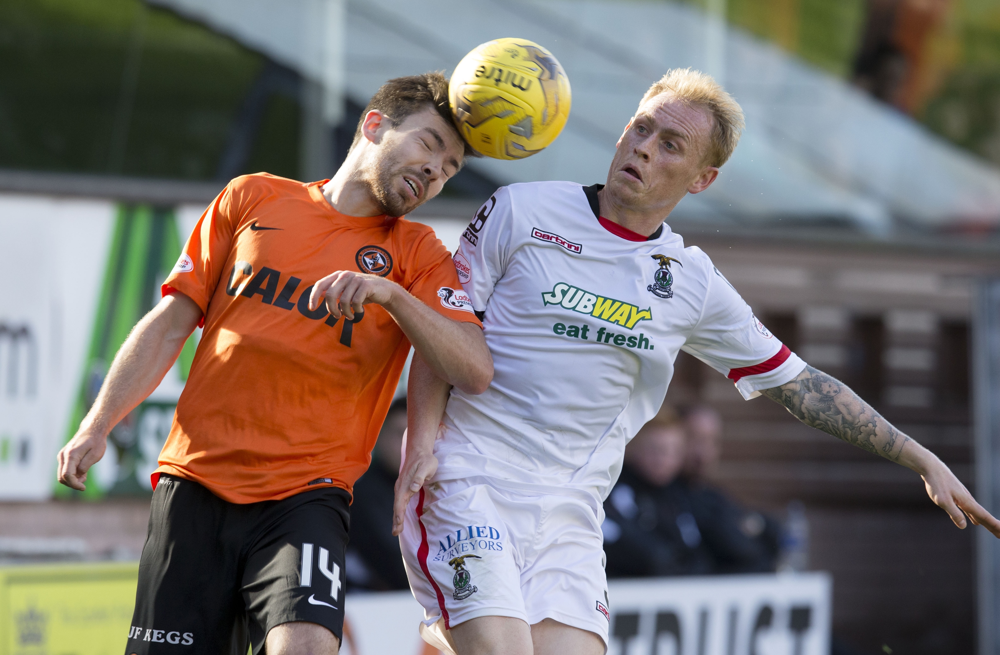 Carl Tremarco competes with Dundee United midfielder Ryan Dow