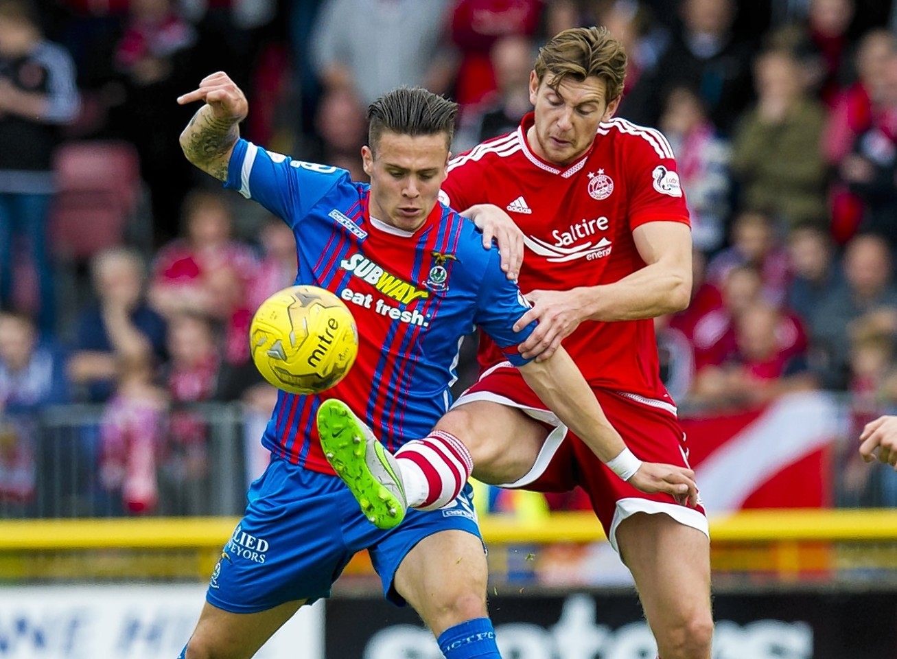 Miles Story and Ash Taylor challenge for the ball 