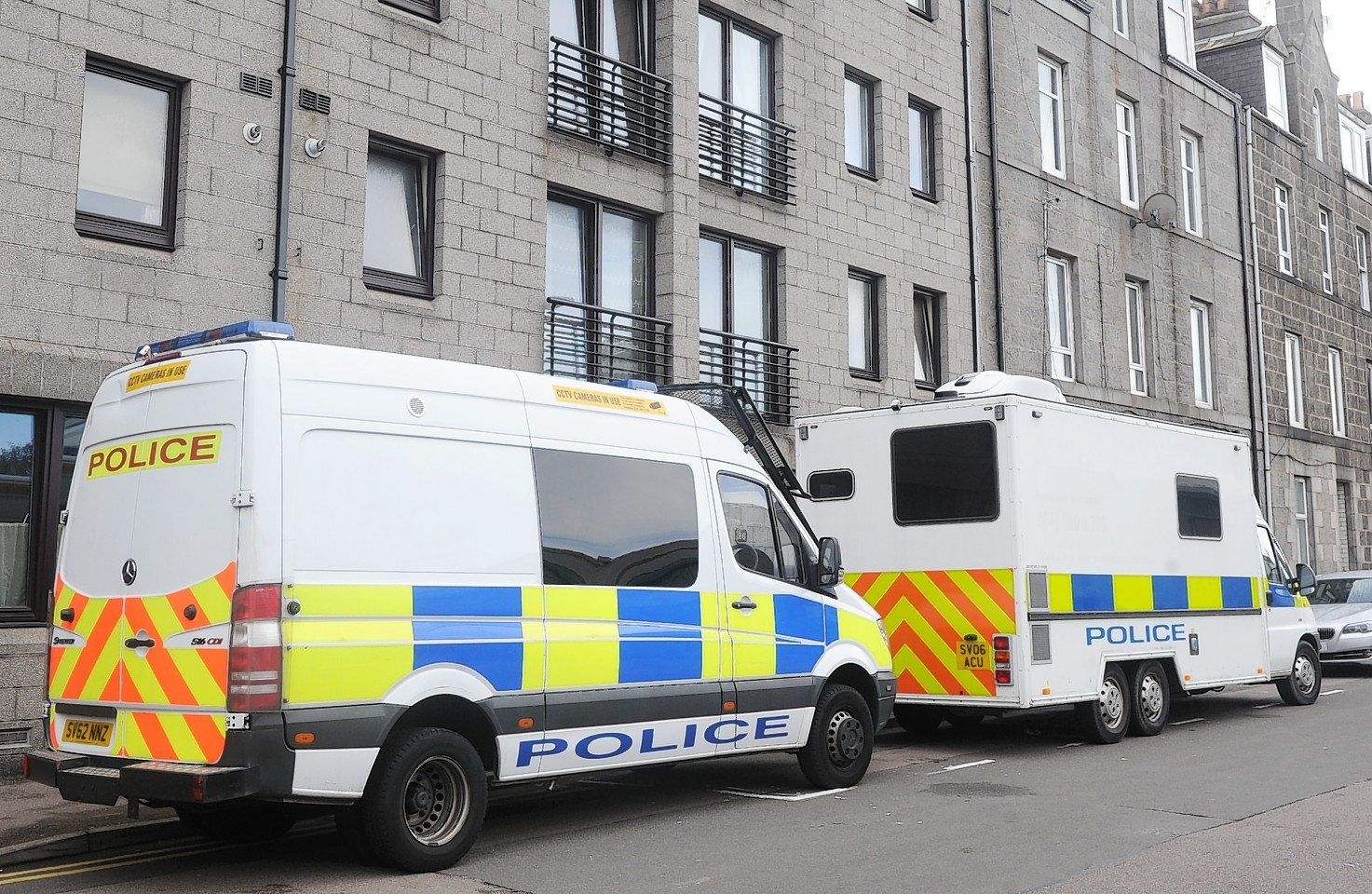 Police outside the Hollan Street flat where James Chadwick was murdered in September last year