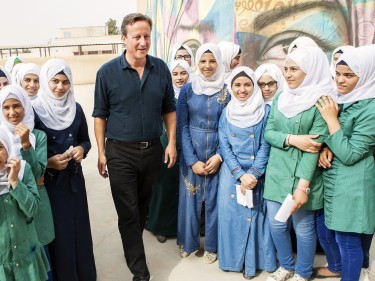 Zaatari, Jordan, 2015 - UK Prime Minister David Cameron visits Mercy Corps and UK Aid staff members at the Zaatari refugee camp in Jordan, and girls in the CSSF program in one of the camp's schools.