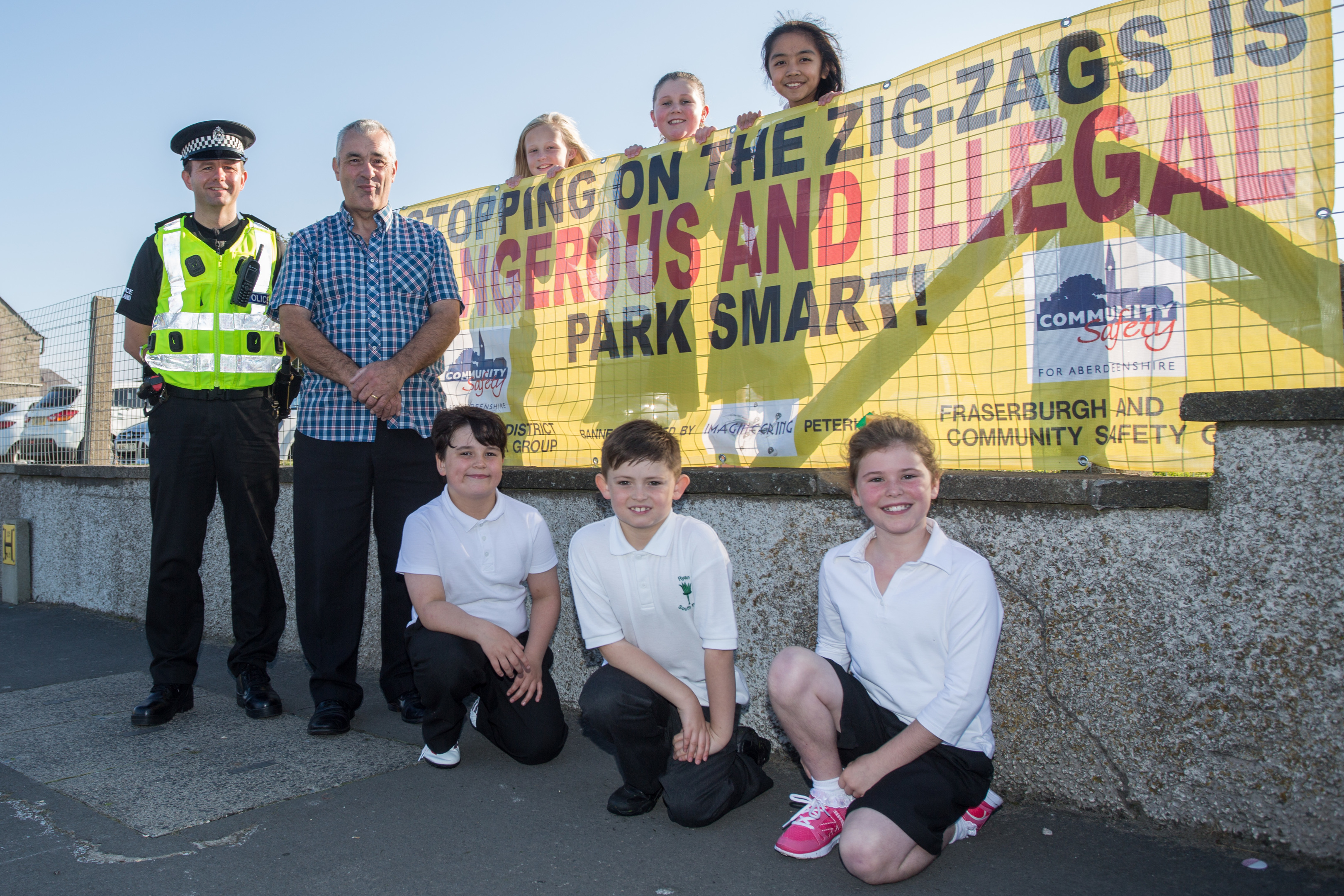 PC Wayne Bedford and safety group chairman Brian Topping with pupils