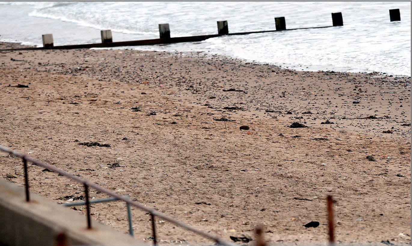 Police at the scene of the bomb washed-up on Aberdeen beach