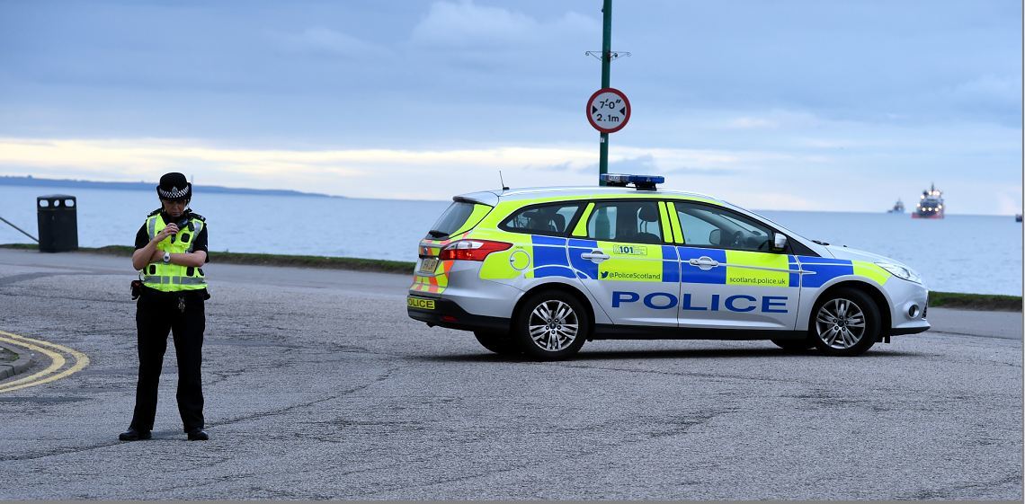 Police at the scene of the bomb washed-up on Aberdeen beach