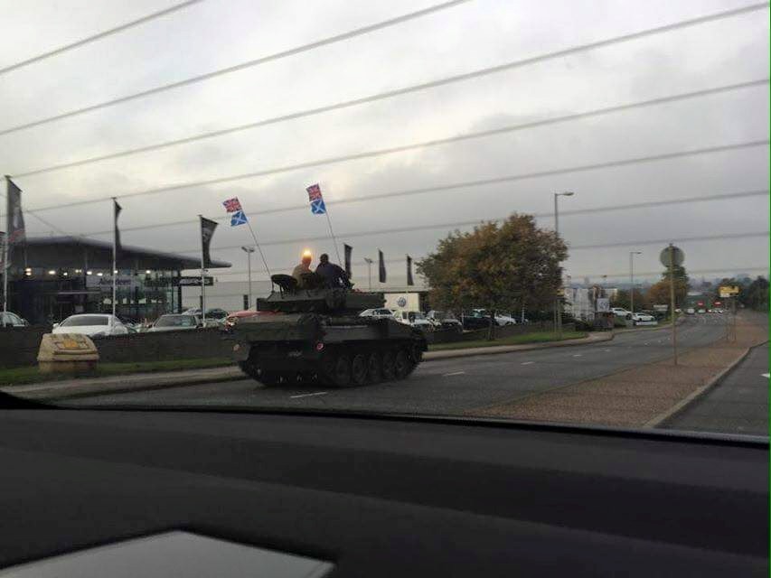 Army tank seen cruising down city road