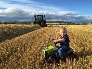 Claire Grant sent in this snap of her son Brodie, 1, keeping an eye on his Dad bailing at Kindrought, Strichen. 