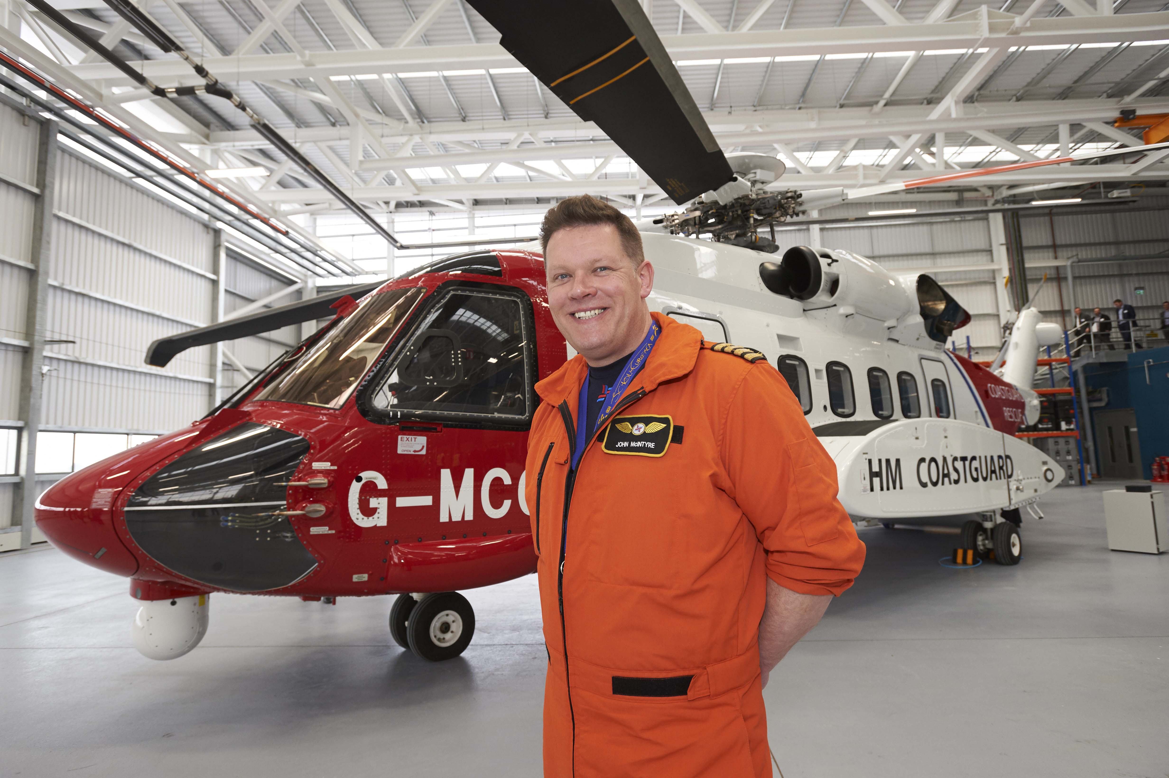 Chief Pilot Captain John McIntyre beside the  Sikorsky S92 helicopter