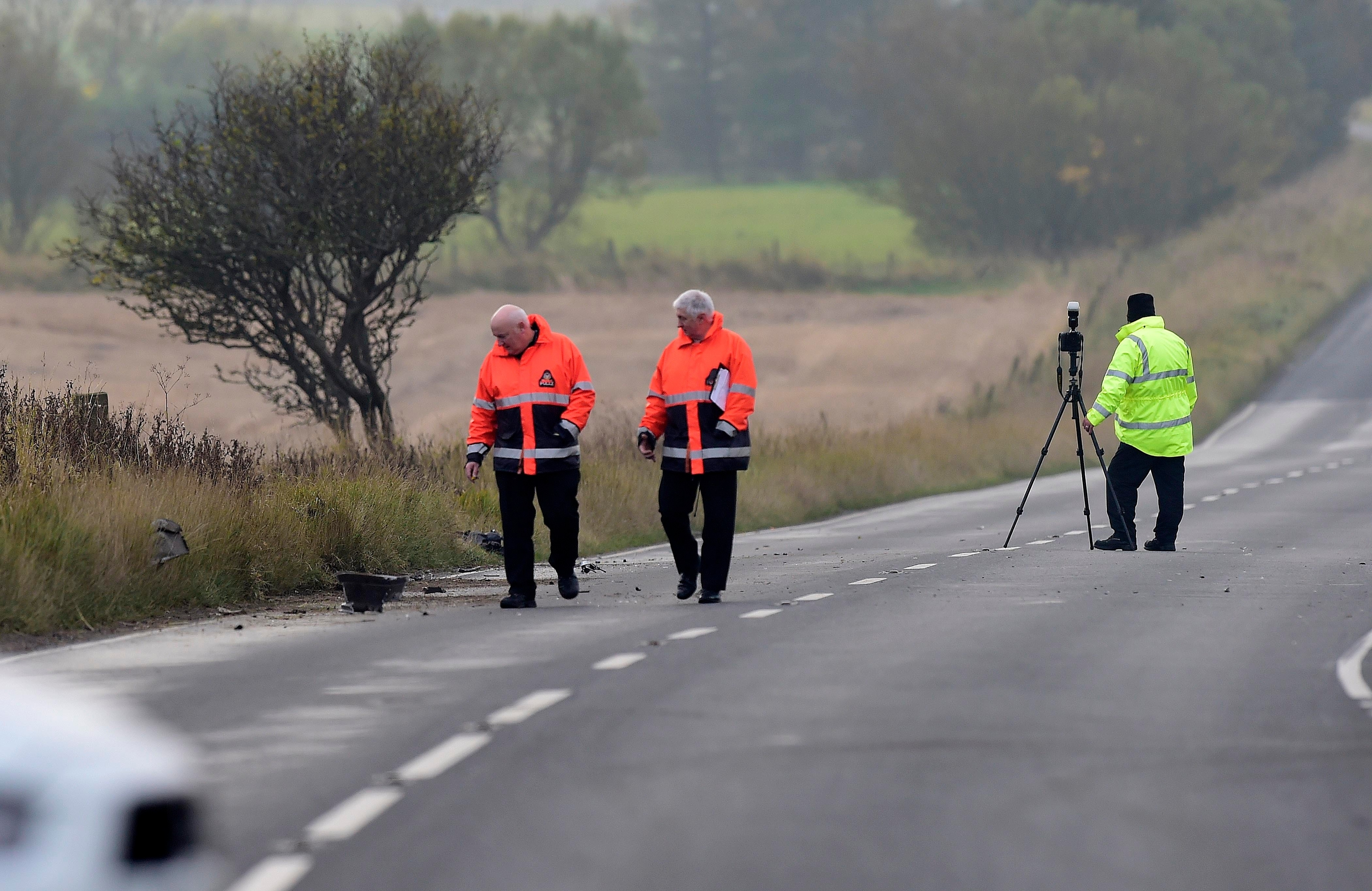 Accident investigators at the scene of the crash on the a952 near the fetterangus turn off where a motorbike and car collided.