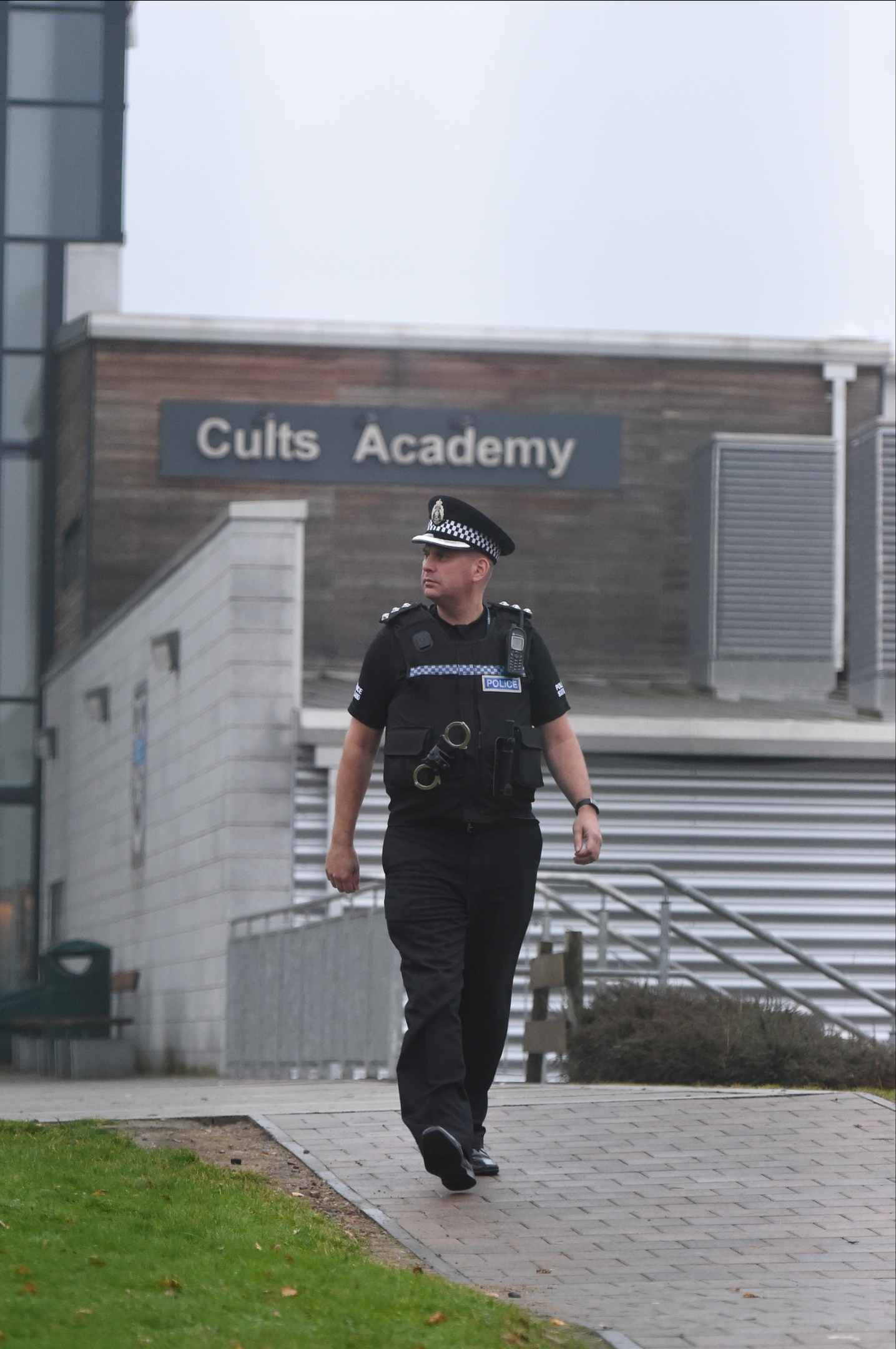 A police officer outside Cults Academy this afternoon 