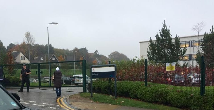 A police officer stands guard outside the school 