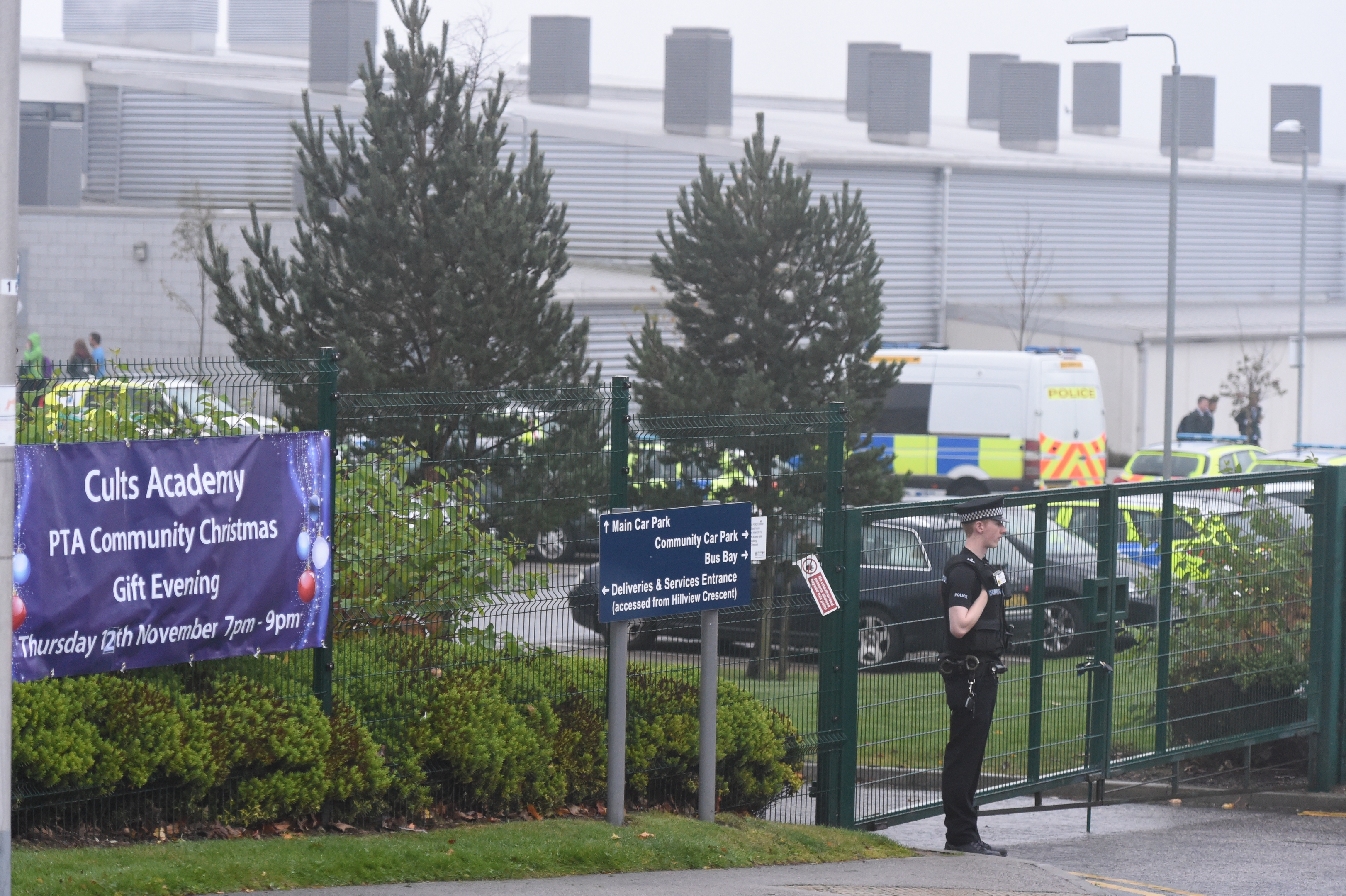 A policeman stands guard outside Cults Academy 