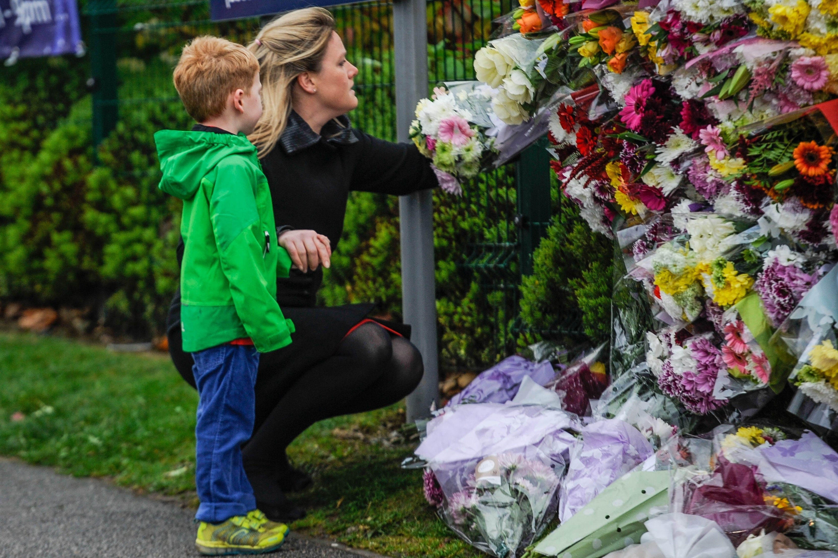 Shona Hamilton, 39, and her son Dylan Hamilton, 4, are seen laying a bouquet of flowers at Cults Academy 