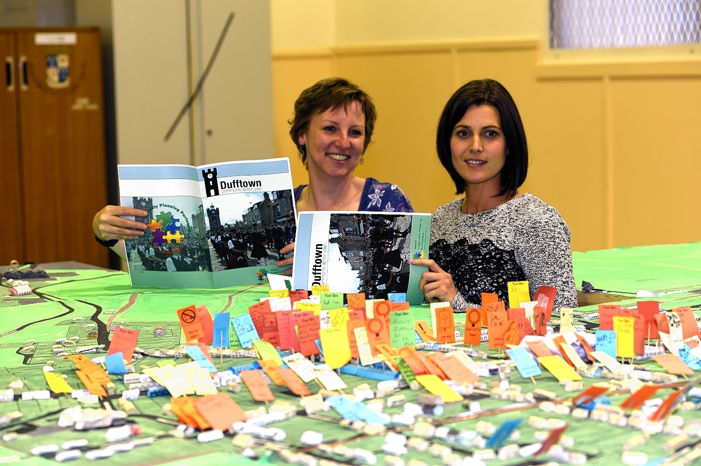 Eleanor Candy, left, and Nicky Alexander, right, pictured with the Action Plan and a 3d map of Dufftown. Picture by Gordon Lennox