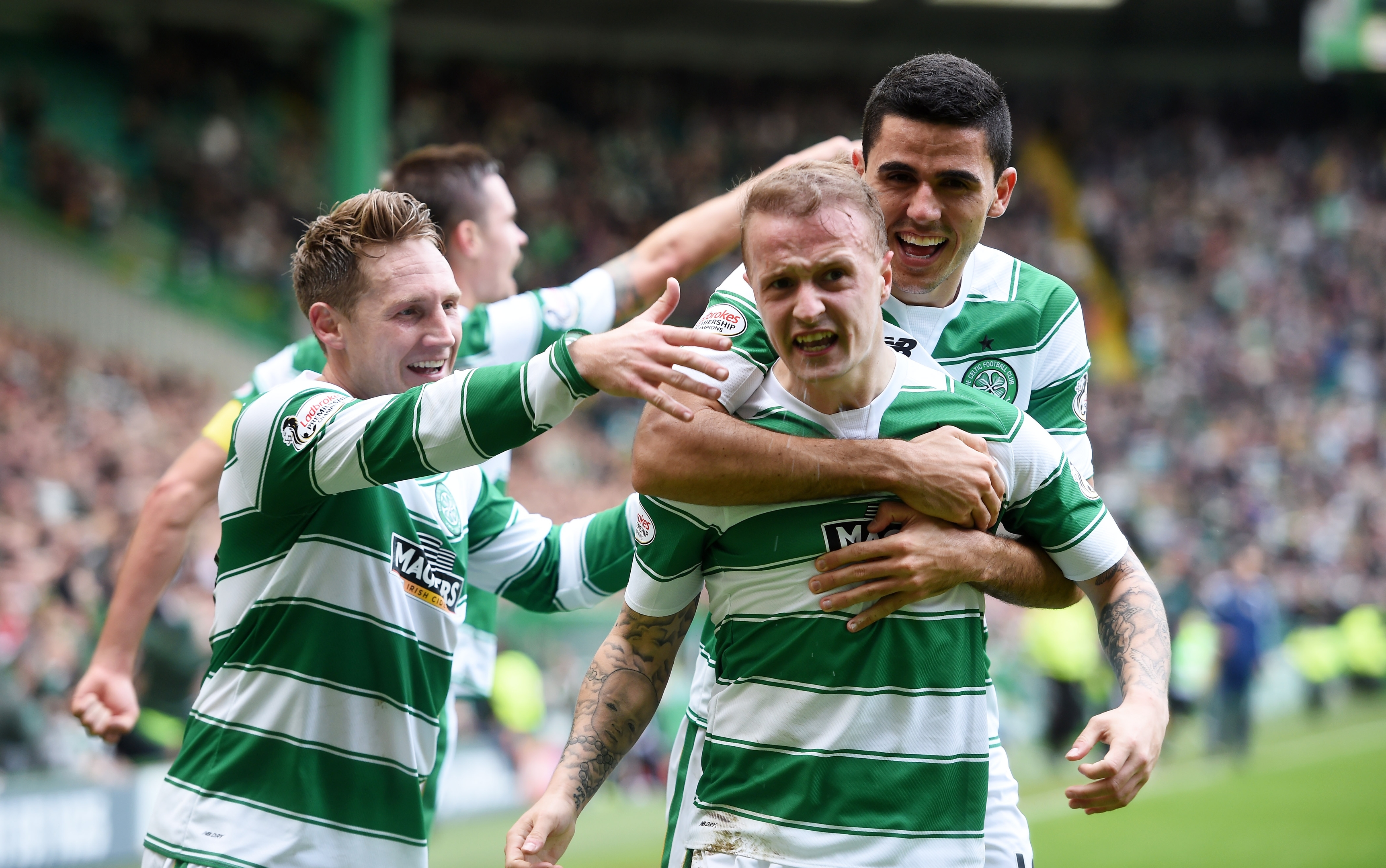 Celtic's Leigh Griffiths celebrates scoring from the spot with team-mates Tom Rogic (right) and Kris Commons