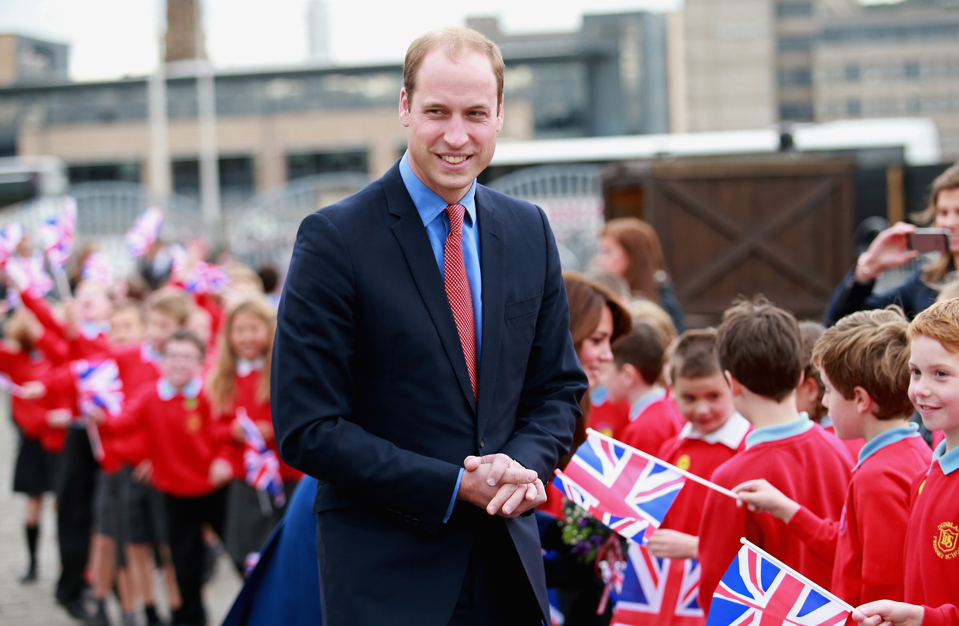  Children wave Union Jacks as Prince William, Duke of Cambridge arrives at RSS Discovery 