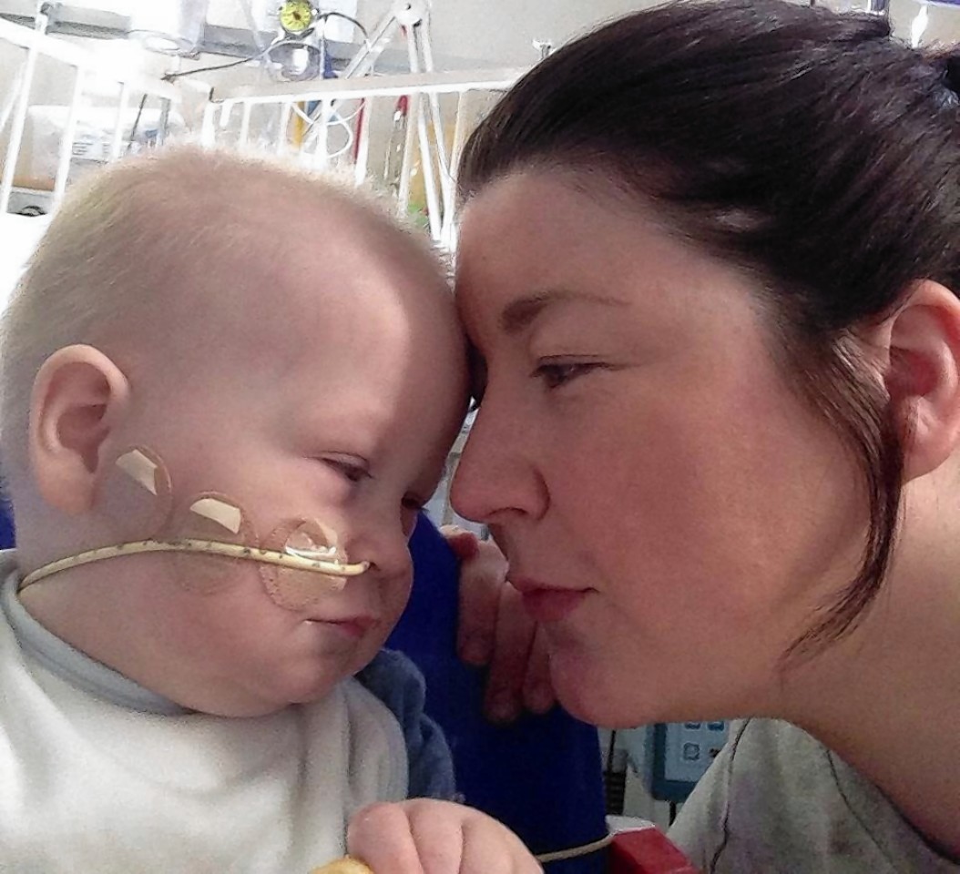 Kai with his mum in April aged 16 months after had his operation.