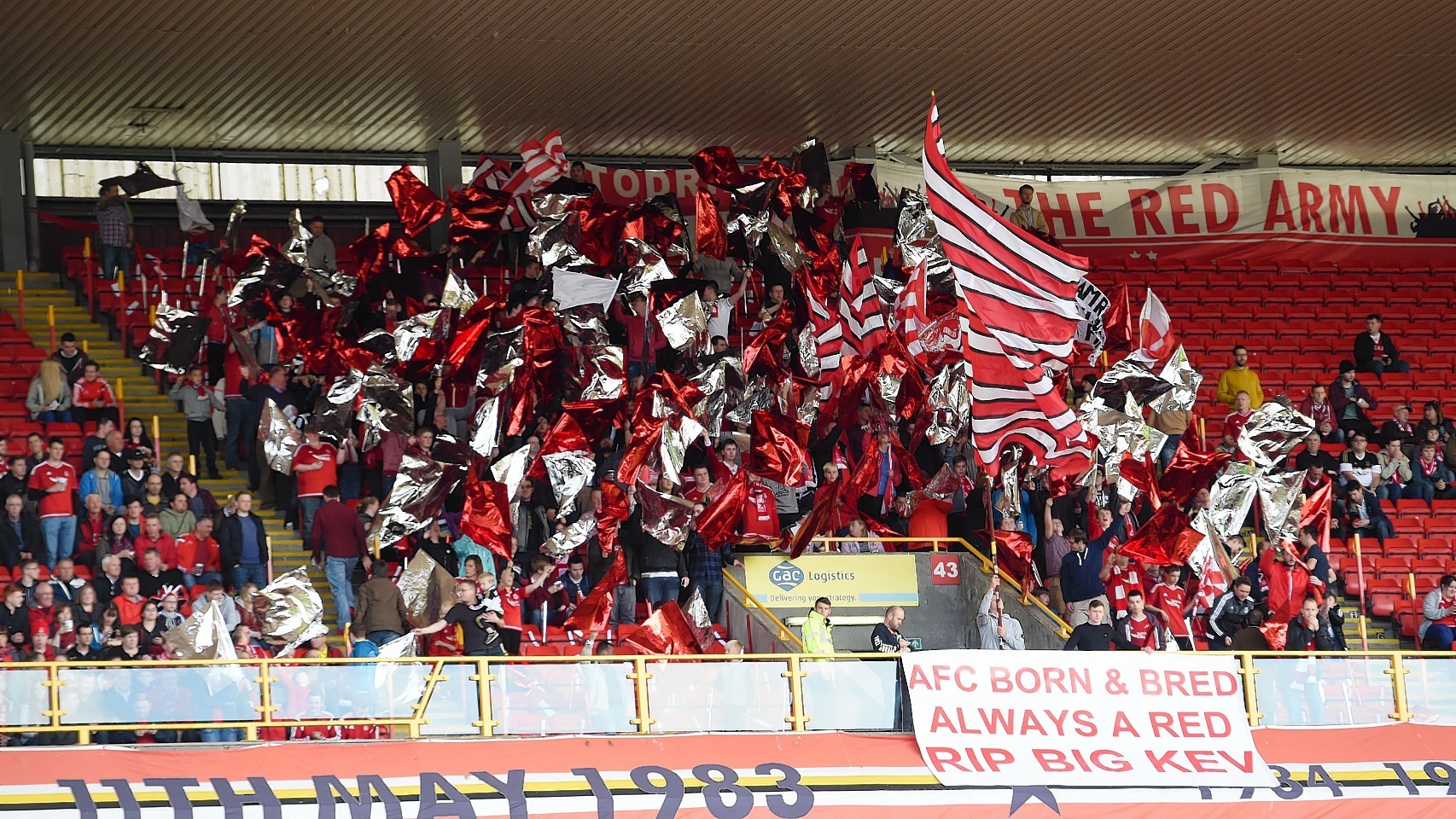 Fans display a banner in memory of football coach and Aberdeen fan Kevin Bartlet on Saturday.