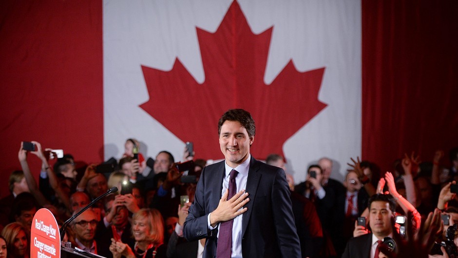 Liberal leader Justin Trudeau stands on stage after becoming Canada's new prime minister after beating Conservative Stephen Harper. (Sean Kilpatrick/The Canadian Press via AP)