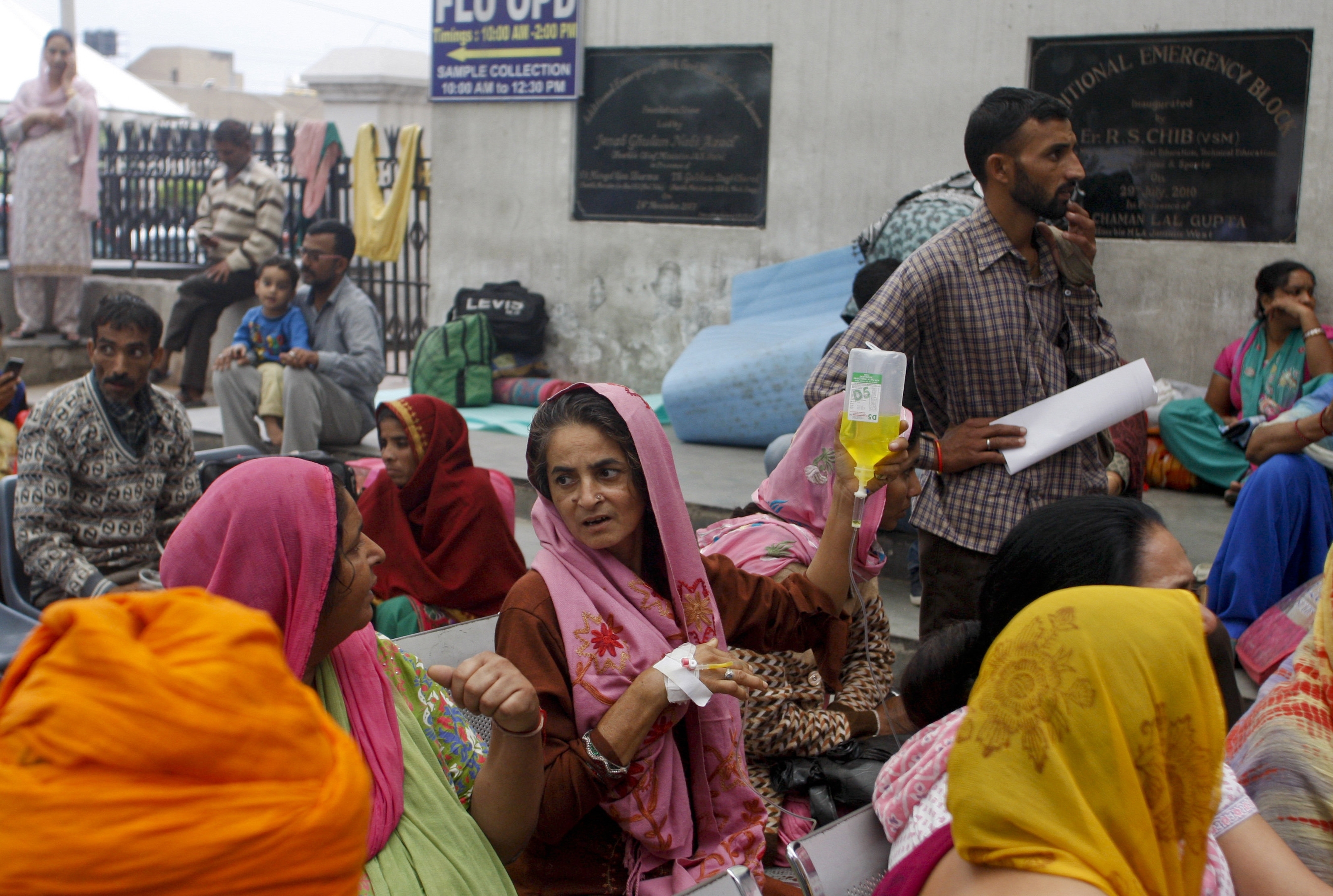 Patients who were shifted outdoors at the government medical college hospital sit after a strong tremor was felt in Jammu, India