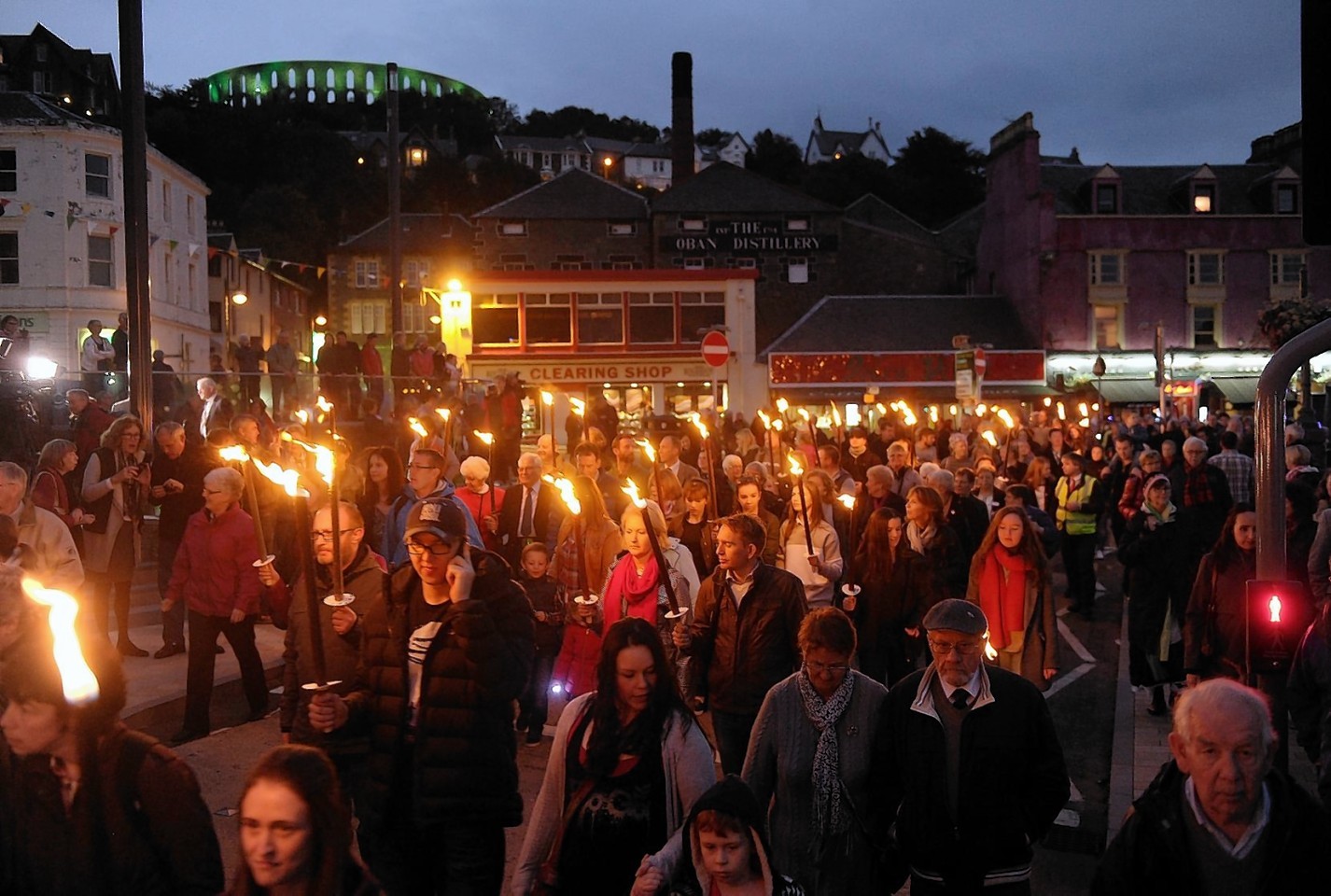 The openning torch light procession of the Royal National Mod makes its way through the streets of Oban