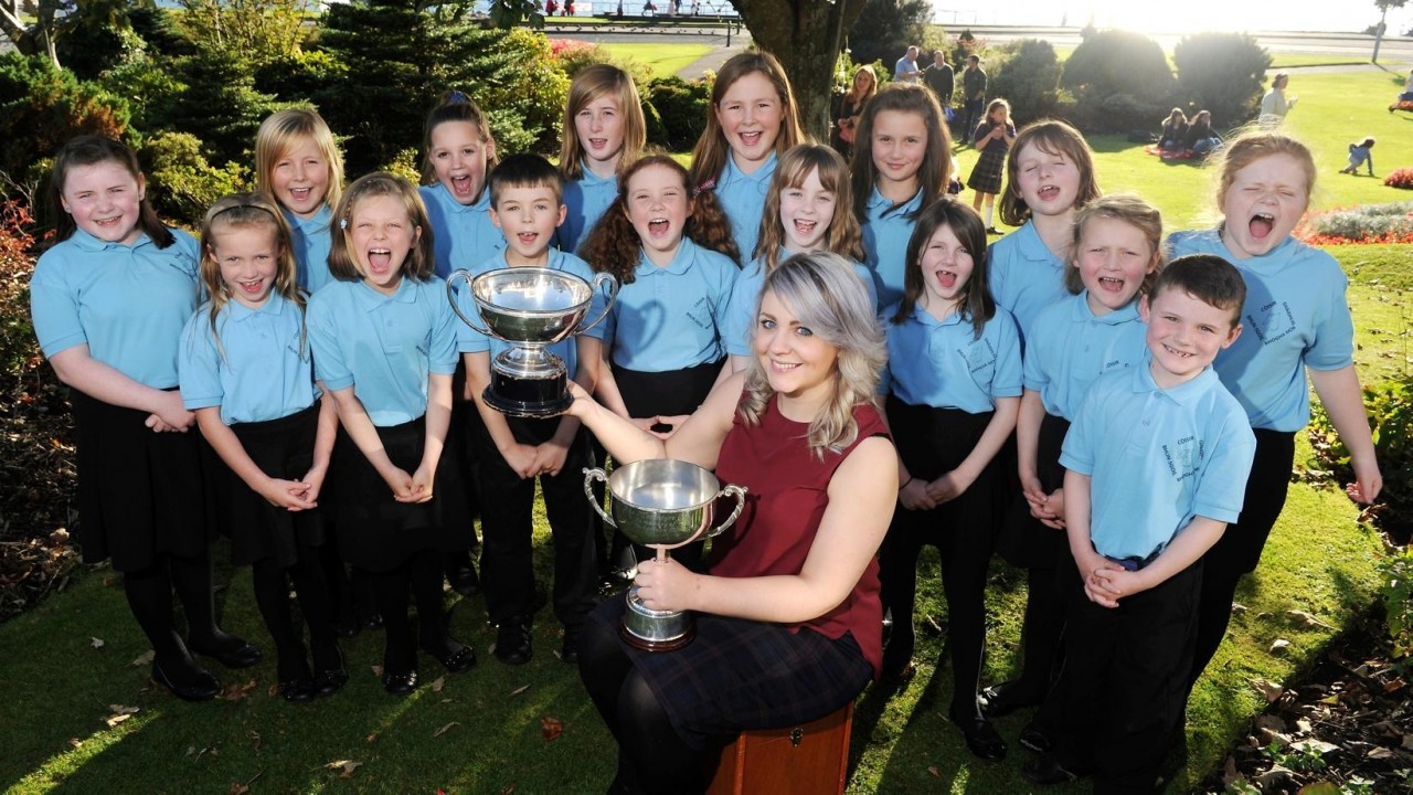 Clare Jordan, conductor of the Bowmore Primary School Gaelic Choir, Islay with the Olive Campbell MBE Trophy and the Macintyre Trophy won for Puirt-a-beul.