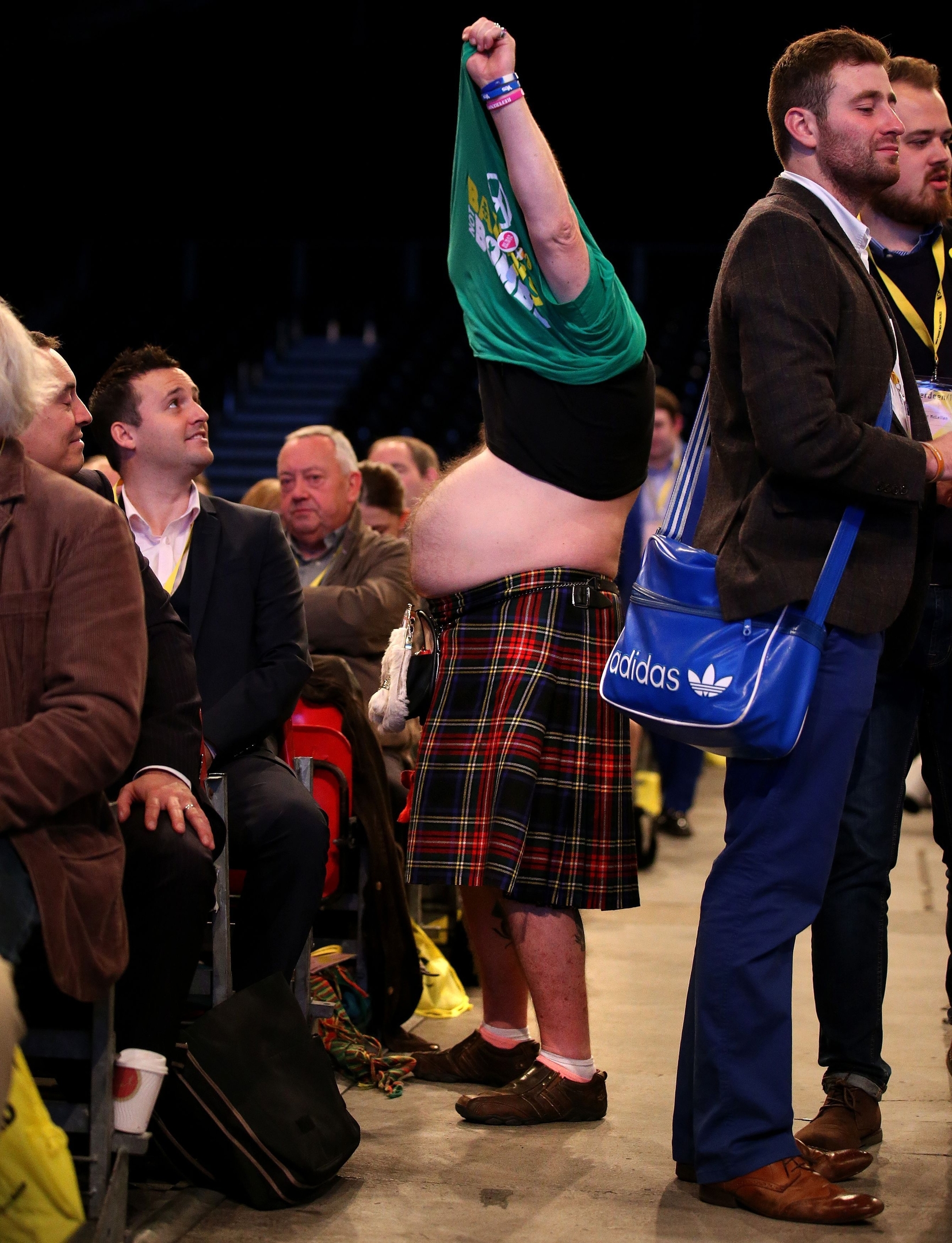 SNP supporter Steve Davies changing his t-shirt in the conference hall at the SNP National Conference