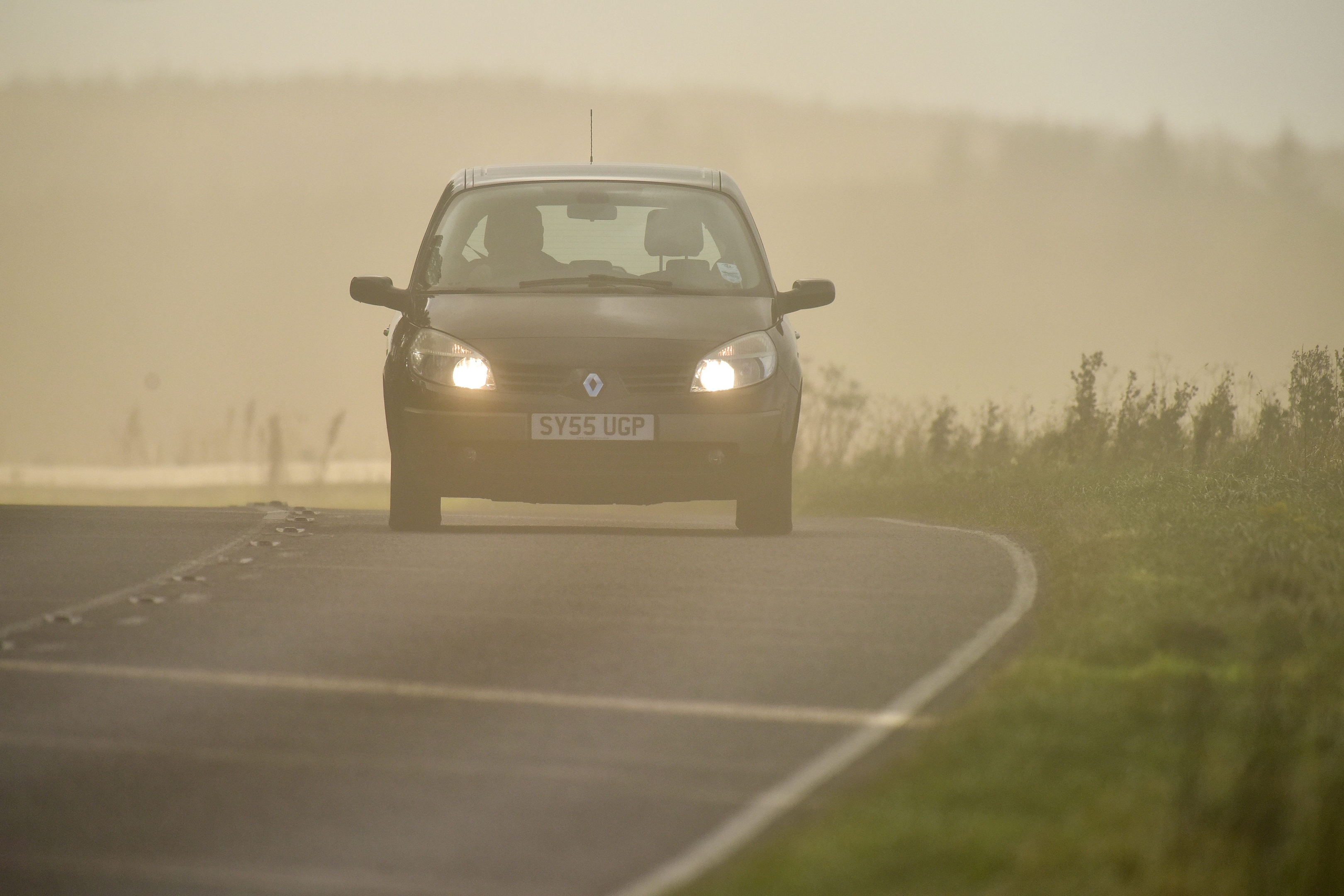 Cars drive through a sandstorm