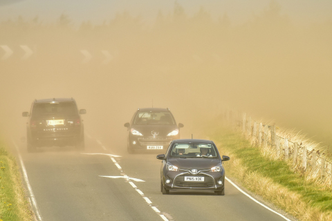 Cars drive through a sandstorm, caused by high winds, near Elgin, Moray on October 22 2015. High winds battered the north of Scotland today, Thursday.