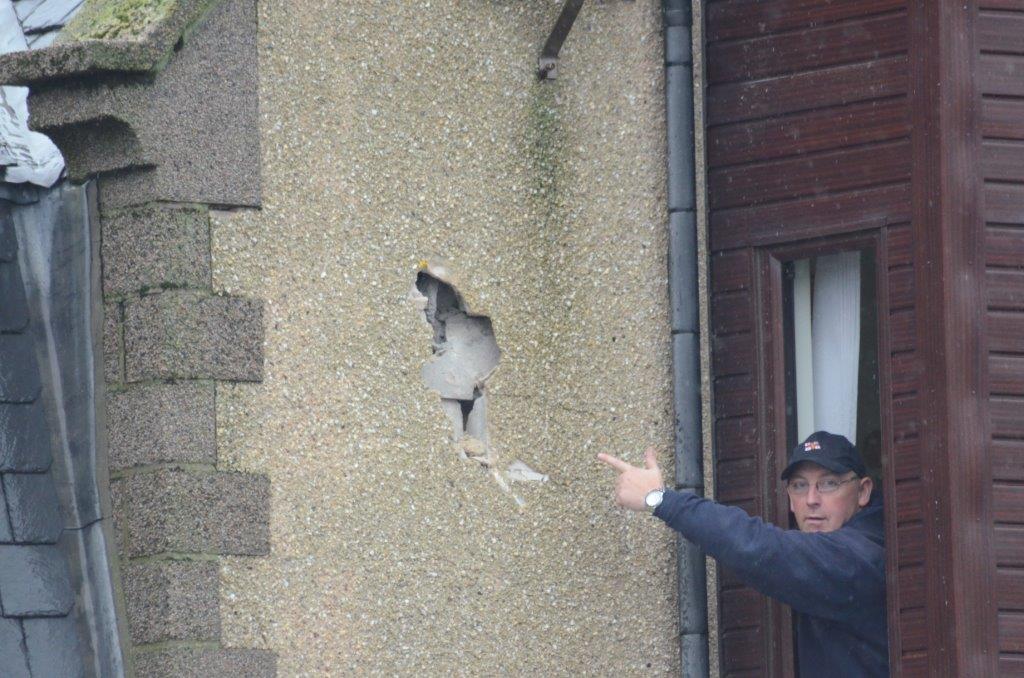 Victor Sutherland points out the damage to the station