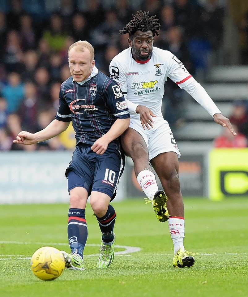 Inverness Andrea Mutombo (right) challenges for the ball with Liam Boyce