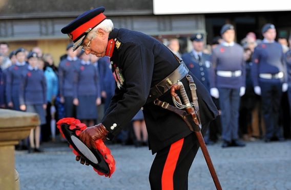 The Lord Lieutenant of Moray, Lt Col Grenville Johnston, lays a wreath of poppies.