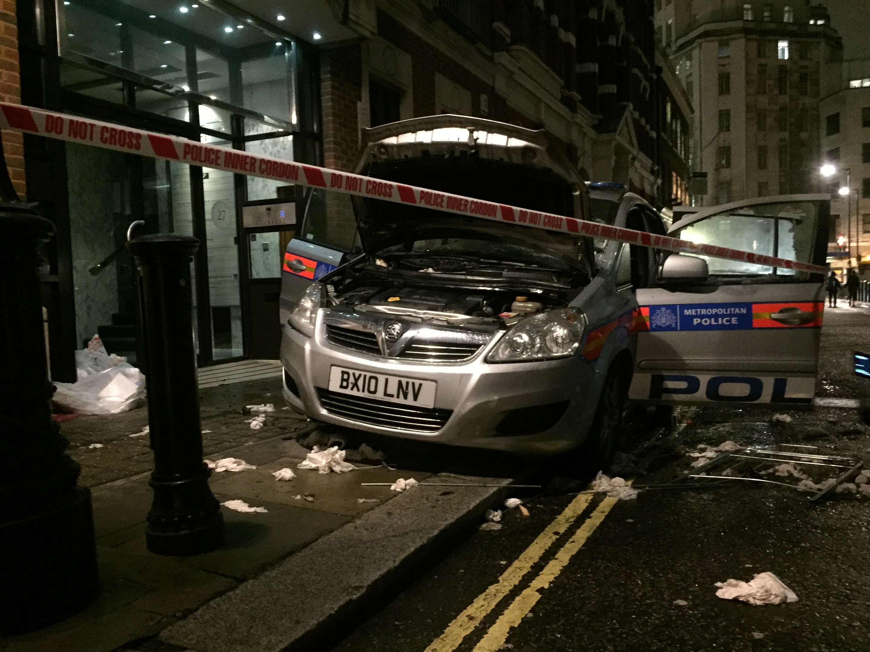 A vandalised police car on Queen Anne's Gate in central London, during the Million Mask March