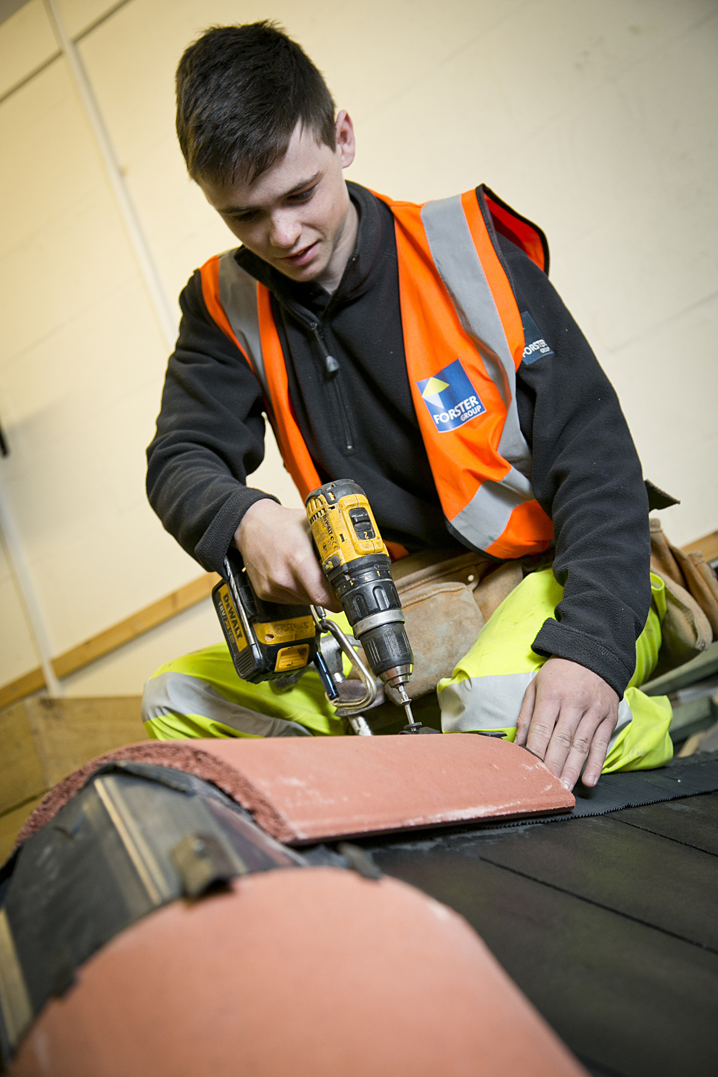 Apprentice Jordan Boyle fixing a ridge tile in Forster's Skills Academy