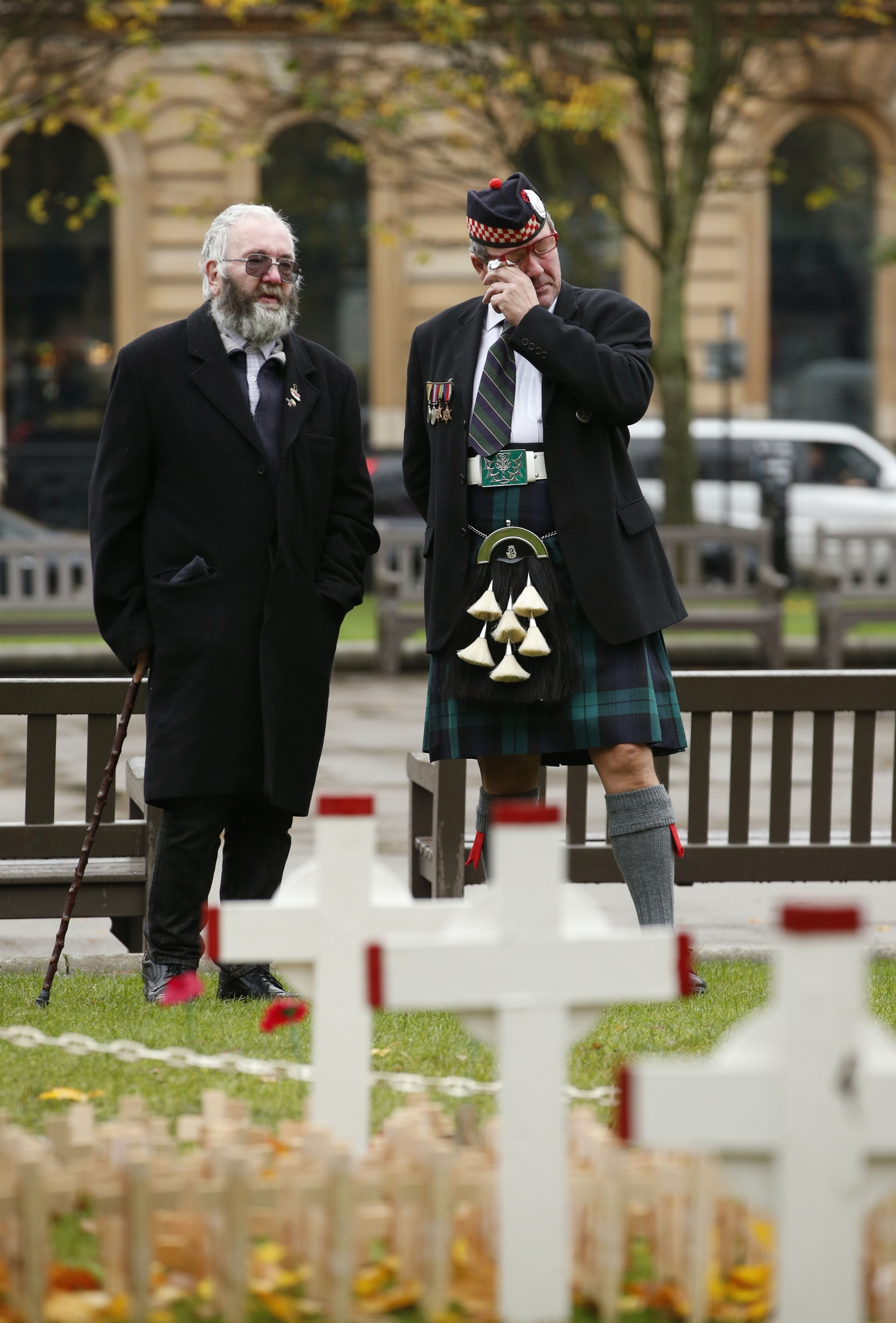 James McEwan (right), who served with the Argyll and Sutherland Highlanders, sheds a tear as he looks at the garden of remembrance in George Square, Glasgow, alongside Peter Ferguson, who lost his son in the Iraq conflict. PRESS ASSOCIATION Photo. Picture date: Wednesday November 11, 2015. Two minutes silence is set to be observed to mark Armistice Day, the anniversary of the end of the First World War. 