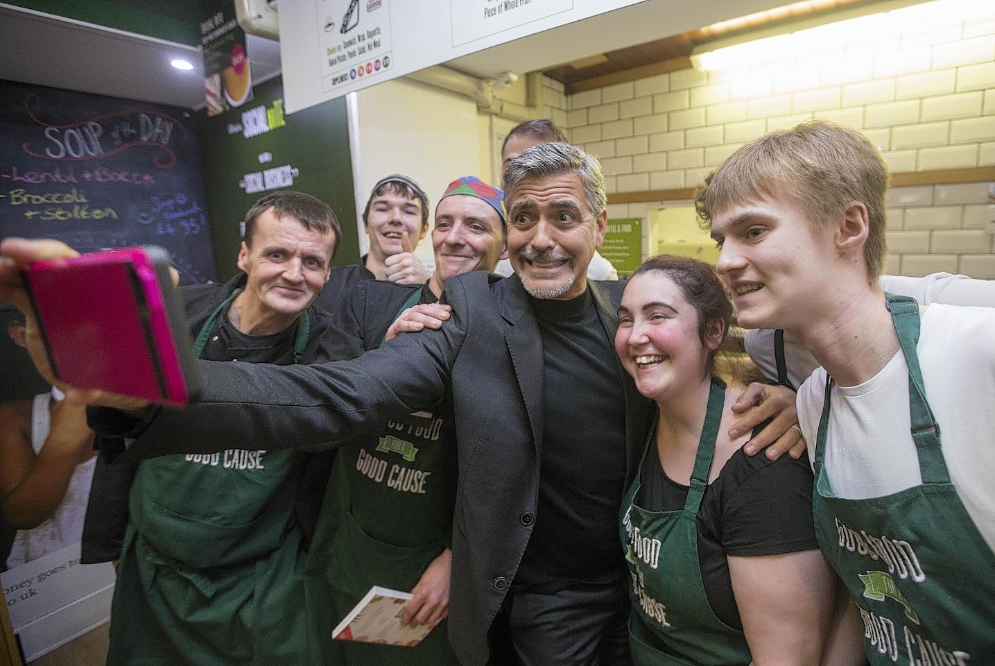 Clooney and the cafe staff gather for a selfie