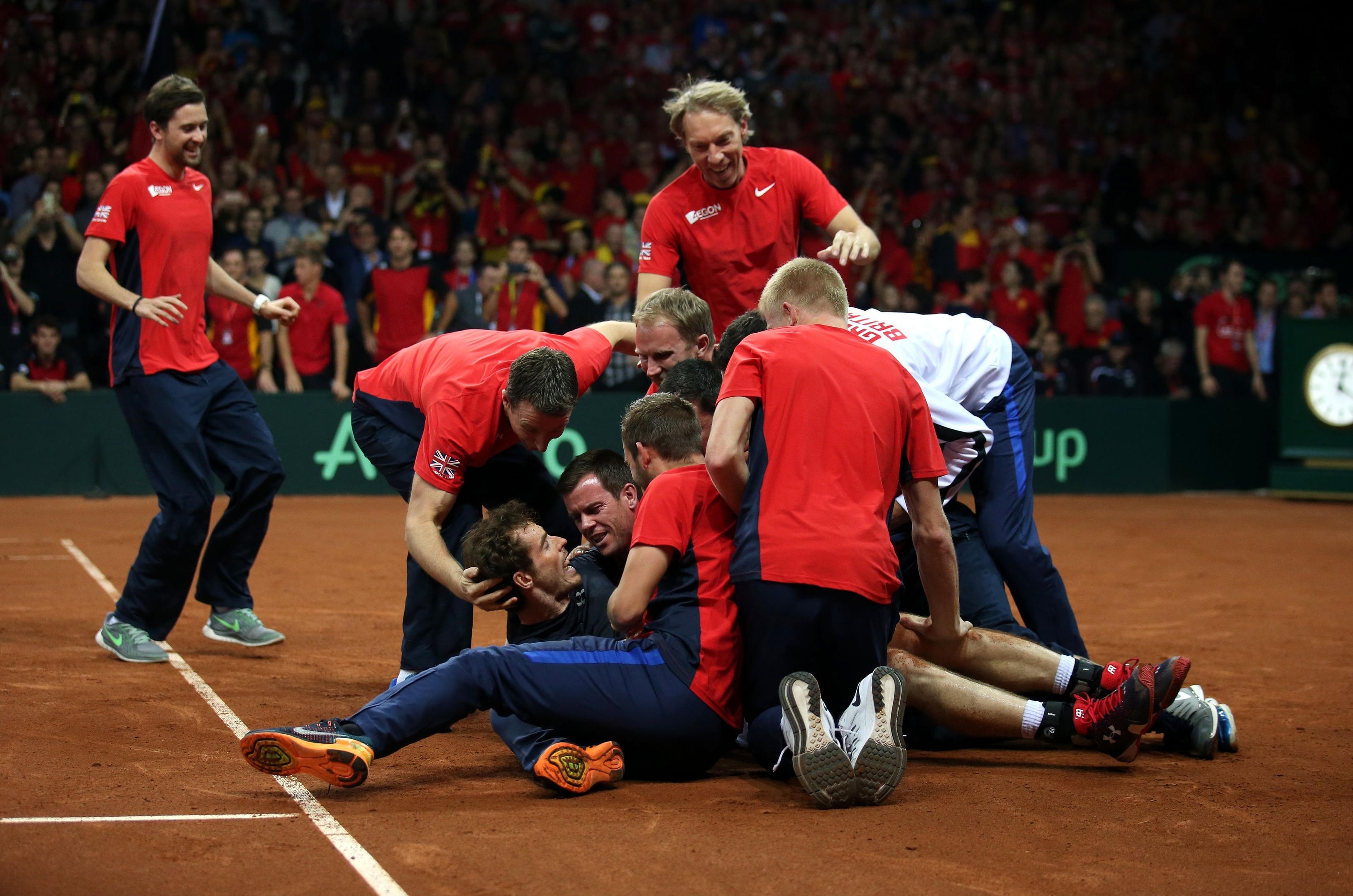 Great Britain's Andy Murray is mobbed by his team-mates after beating David Goffin to win the Davis Cup Final at the Flanders Expo Centre, Ghent. 