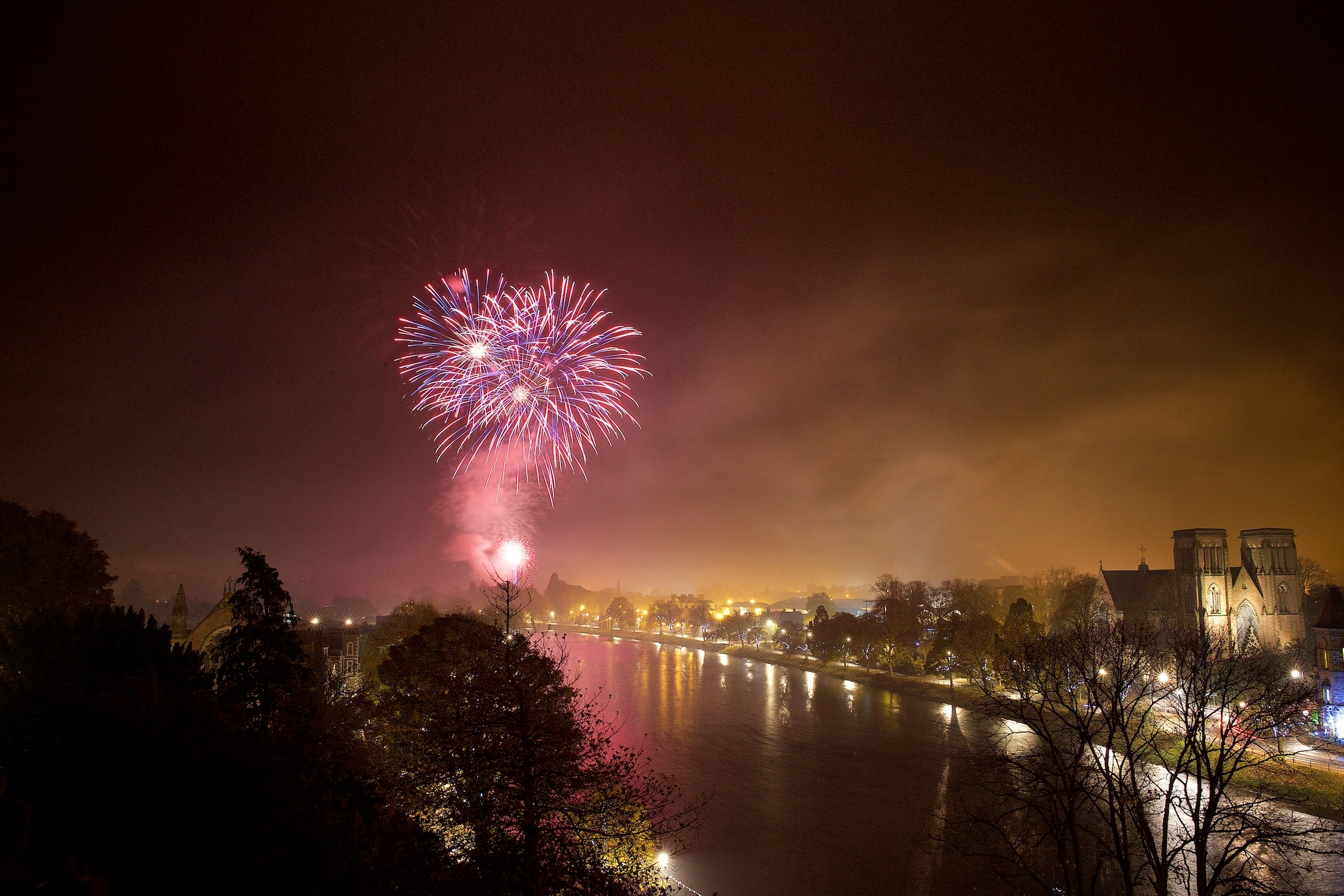 Inverness firework display lights up the sky and the river Ness. 